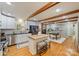 Updated kitchen featuring wooden beams, white cabinets, stainless steel appliances, and an island at 3901 Kitley Pl, Charlotte, NC 28210
