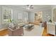 Open-concept living room with hardwood floors, large windows, and comfortable seating arrangement at 3901 Kitley Pl, Charlotte, NC 28210