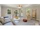 Bright living room boasts plush seating, stylish decor, and ample natural light from large windows at 3901 Kitley Pl, Charlotte, NC 28210