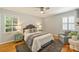 Comfortable main bedroom features plantation shutters, ceiling fan, hardwood floors, and soft decor at 3901 Kitley Pl, Charlotte, NC 28210