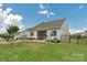 Fenced backyard featuring a covered porch, patio area, and lush lawn, offering privacy and space for recreation at 4040 Deep River Way, Waxhaw, NC 28173