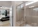 Bathroom showing a glass-doored shower and view into the connected bedroom at 4040 Deep River Way, Waxhaw, NC 28173