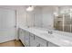 Spacious bathroom features double sinks, a large mirror, and a glass-enclosed shower at 4040 Deep River Way, Waxhaw, NC 28173
