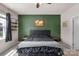 Stylish bedroom with a dark green accent wall, modern furniture, and neutral carpet at 4040 Deep River Way, Waxhaw, NC 28173