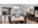 Inviting dining room with a table set for a meal, seamlessly connected to the living area at 4040 Deep River Way, Waxhaw, NC 28173