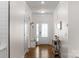 Hallway featuring coat rack and decorative glass door to the outside at 4040 Deep River Way, Waxhaw, NC 28173