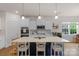 Bright kitchen with white cabinets, stainless steel appliances, and center island with seating at 4040 Deep River Way, Waxhaw, NC 28173