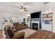 Cozy living room with comfortable couches, fireplace, and custom shelving at 4040 Deep River Way, Waxhaw, NC 28173