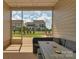Cozy enclosed patio with outdoor furniture and a scenic view of the backyard at 4040 Deep River Way, Waxhaw, NC 28173