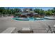 Resort-style pool area with a thrilling waterslide, surrounded by lounge chairs, perfect for summer relaxation at 4040 Deep River Way, Waxhaw, NC 28173