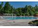Tranquil community pool with a pergola and plenty of lounge chairs, perfect for relaxing and enjoying the summer at 4040 Deep River Way, Waxhaw, NC 28173