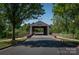 Charming covered bridge nestled among mature trees, creating a picturesque and welcoming neighborhood entrance at 4040 Deep River Way, Waxhaw, NC 28173
