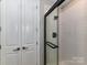 Elegant bathroom featuring a glass-enclosed shower, white tiled walls, and storage space at 4625 Piedmont Row Dr # 410, Charlotte, NC 28210