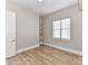 Bright bedroom featuring hardwood floors, built-in shelves, and a window, offering a cozy and inviting space at 4625 Piedmont Row Dr # 410, Charlotte, NC 28210