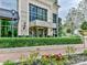 Elegant building exterior with well-manicured landscaping and inviting entrance at 4625 Piedmont Row Dr # 410, Charlotte, NC 28210