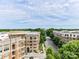 An exterior street view showcasing the urban landscape, and skyline in the distance at 4625 Piedmont Row Dr # 410, Charlotte, NC 28210