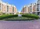 Beautiful exterior view of brick buildings, lush landscaping, and brick paved area at 4625 Piedmont Row Dr # 410, Charlotte, NC 28210
