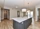 Open kitchen layout featuring a large center island with white countertops, and natural light at 4625 Piedmont Row Dr # 410, Charlotte, NC 28210