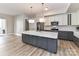 Open kitchen features a large island, stainless steel appliances, and access to a balcony at 4625 Piedmont Row Dr # 410, Charlotte, NC 28210