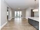 Open-concept living room featuring wood floors and sliding glass doors to balcony at 4625 Piedmont Row Dr # 410, Charlotte, NC 28210