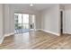Bright living room with wood floors and sliding glass doors to a balcony at 4625 Piedmont Row Dr # 410, Charlotte, NC 28210