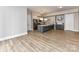 Spacious living area with modern kitchen featuring a large island and light wood flooring at 4625 Piedmont Row Dr # 410, Charlotte, NC 28210