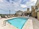 Inviting swimming pool with tiled edges, lounge seating, and a nearby covered pavilion at 4625 Piedmont Row Dr # 410, Charlotte, NC 28210