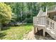 The beautiful backyard features a lush lawn, stairs to a deck and an above-ground pool at 4700 Hickory Grove Rd, Mount Holly, NC 28120