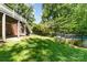 Spacious backyard featuring a tiered deck, green lawn and mature trees at 4700 Hickory Grove Rd, Mount Holly, NC 28120