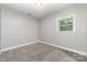A clean and well-lit bedroom features neutral walls and carpet at 4700 Hickory Grove Rd, Mount Holly, NC 28120