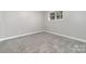 This bedroom features neutral walls, plush carpet, and a bright window at 4700 Hickory Grove Rd, Mount Holly, NC 28120