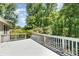 A spacious deck with beautiful wood railings and lush greenery views at 4700 Hickory Grove Rd, Mount Holly, NC 28120