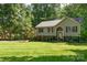 Charming two-story home with well-manicured lawn and mature trees at 4700 Hickory Grove Rd, Mount Holly, NC 28120