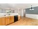 A kitchen area with wooden cabinets, black appliances, and an eat-in dining space at 4700 Hickory Grove Rd, Mount Holly, NC 28120