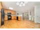 Bright eat-in kitchen with black appliances, light countertops, wooden cabinets, and hardwood floors at 4700 Hickory Grove Rd, Mount Holly, NC 28120