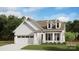 Charming two-story home with white siding, dormer windows, covered porch and attached two-car garage at 5059 Valita Rd, York, SC 29745