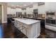 Spacious kitchen with quartz island, stainless appliances, two-tone cabinets, and modern pendant lights at 5059 Valita Rd, York, SC 29745