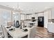Elegant dining room with a view to the kitchen, white cabinets and modern black appliances at 5075 Valita Rd, York, SC 29745