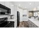 Well-lit kitchen with white cabinets, stainless appliances, and stylish backsplash at 5075 Valita Rd, York, SC 29745