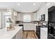 Modern kitchen with white cabinets, an island with bar seating and stainless steel appliances at 5075 Valita Rd, York, SC 29745