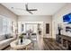 Spacious living room with wood floors, a ceiling fan, and open flow to the dining and kitchen areas at 5075 Valita Rd, York, SC 29745