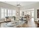 Open-concept living room with wood flooring, a ceiling fan, and large windows for natural light at 5075 Valita Rd, York, SC 29745