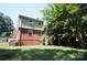 View of the backyard and the back side of the house with an elevated deck at 5127 Murrayhill Rd, Charlotte, NC 28210