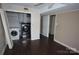 Versatile basement area with wood-look flooring, laundry hookups, and ample space for storage or customization at 5127 Murrayhill Rd, Charlotte, NC 28210