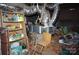 A cluttered basement featuring exposed ductwork and a storage shelf with household items at 5127 Murrayhill Rd, Charlotte, NC 28210