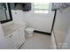 Well-maintained bathroom with a tiled floor, a vanity sink, and a bathtub provides a functional space at 5127 Murrayhill Rd, Charlotte, NC 28210