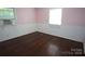 Bright bedroom boasts hardwood floors and natural light, offering a cozy and inviting space at 5127 Murrayhill Rd, Charlotte, NC 28210