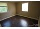 Bedroom with hardwood floors, two windows and neutral paint color at 5127 Murrayhill Rd, Charlotte, NC 28210