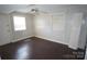 Bright bedroom featuring wood-look walls, hardwood floors, ceiling fan and natural light at 5127 Murrayhill Rd, Charlotte, NC 28210