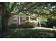 Charming brick home with a front porch, framed by mature tree with lots of shade and curb appeal at 5127 Murrayhill Rd, Charlotte, NC 28210